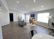 Thumbnail 6 of 25 - Clubhouse lounge area with a grey couch and a white table at Cobalt apartments in kokomo
