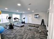 Thumbnail 9 of 25 - A spacious gym with a variety of exercise equipment at Cobalt Apartments in Kokomo