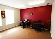 Thumbnail 14 of 15 - two desks with computers and chairs at canterbury apartments in kalamazoo, mi
