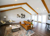 Thumbnail 3 of 14 - Lounge are with a couch and a table at Maple Tree Apartments in LaPorte, IN