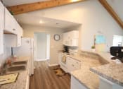 Thumbnail 4 of 14 - Clubhouse kitchen with a sink stove and refrigerator at Maple Tree Apartments in LaPorte, IN