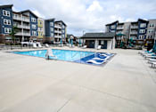 Thumbnail 34 of 34 - A large swimming pool surrounded by apartment buildings.