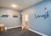 Thumbnail 12 of 34 - a room with a blue wall with a name on it