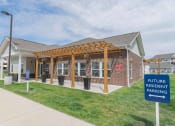 Thumbnail 2 of 25 - Crossing at Grove City Clubhouse building with a pergola and a sign