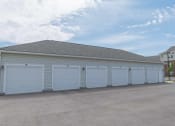 Thumbnail 24 of 25 - A row of large white garages with doors