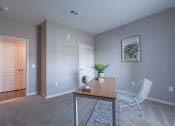Thumbnail 20 of 25 - Adesk with a chair in a room with a door to a hallway at Crossing at Grove City apartments in Grove City, OH