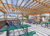 Thumbnail 7 of 25 - Crossing at Grove Citys clubhouse patio with green picnic tables