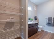 Thumbnail 22 of 25 - Bathroom with a sink and a toilet and shelves at grove city apartments