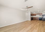 Thumbnail 7 of 50 - A room with a ceiling fan and wooden flooring.
