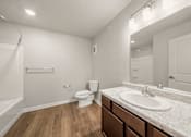 Thumbnail 17 of 50 - A white bathroom with a toilet, sink, and bathtub.