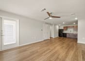 Thumbnail 1 of 50 - A room with a ceiling fan and wooden flooring.