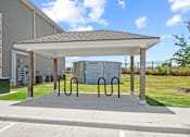 Thumbnail 43 of 50 - A covered parking area with a concrete floor and a metal railing.
