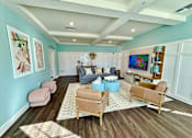 Thumbnail 13 of 34 - clubhouse living room a couch, chairs, and a tv at flats at sundown apartments in north port florida