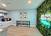 Thumbnail 15 of 34 - A room with a green wall and a neon sign that says "All you need is coffee".