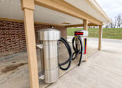 Thumbnail 16 of 19 - A gas station with a red and white sign that says "McGUIR".