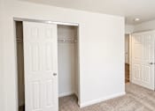 Thumbnail 19 of 19 - A white door is open to a hallway.