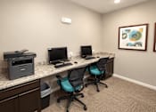 Thumbnail 14 of 19 - A room with a desk, two chairs, a monitor, a keyboard, and a printer.