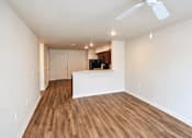 Thumbnail 3 of 19 - A room with wooden floors and a ceiling fan.