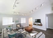 Thumbnail 4 of 17 - Living room with a tv, couch, chair and coffee table