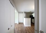 Thumbnail 9 of 17 - an empty room with a kitchen in the background