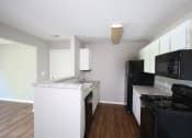 Thumbnail 8 of 17 - a kitchen with white cabinets and black appliances