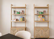 Thumbnail 7 of 21 - Two shelves with books and boxes on them.