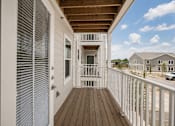 Thumbnail 3 of 21 - A white deck with a wooden floor and a white railing.