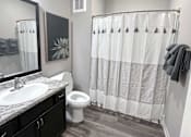 Thumbnail 30 of 31 - a bathroom with a shower toilet and sink and a mirror