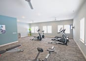 Thumbnail 19 of 24 - A spacious gym with a variety of exercise equipment.