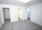 Thumbnail 7 of 11 - an empty room with white walls and carpet and a closet