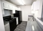 Thumbnail 5 of 11 - a kitchen with black appliances and white cabinets