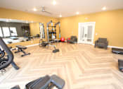 Thumbnail 13 of 20 - A spacious home gym with a variety of exercise equipment.