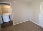 Thumbnail 5 of 20 - A room with a white door and a white fridge.