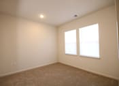 Thumbnail 11 of 28 - a living room with two windows and a carpeted floor