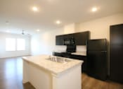 Thumbnail 12 of 28 - a kitchen with black appliances and a white counter top with a sink