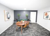 Thumbnail 3 of 25 - A conference room with a table, chairs, and two potted plants.