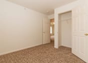 Thumbnail 23 of 24 - A room with a carpeted floor and two doors.
