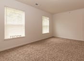 Thumbnail 20 of 24 - A room with a carpeted floor and a window with blinds.