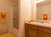 Thumbnail 24 of 24 - A bathroom with a white sink and a white bathtub.