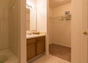 Thumbnail 19 of 24 - A bathroom with a tub, sink, and a mirror.