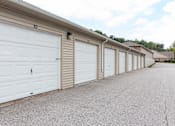 Thumbnail 9 of 24 - A long row of white garage doors are closed.