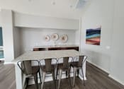 Thumbnail 34 of 58 - a dining room with a table and chairs