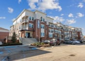 Thumbnail 1 of 22 - Exterior view of The Lofts apartment building with cars parked in front of it