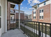 Thumbnail 22 of 22 - the spacious balcony has a view of a yard and apartments