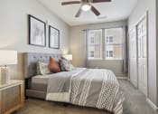 Thumbnail 17 of 22 - a bedroom with a bed and a ceiling fan