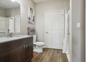 Thumbnail 21 of 22 - a bathroom with a white door and a toilet and a sink