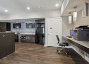 Thumbnail 8 of 22 - an open kitchen and office area with a desk and a chair