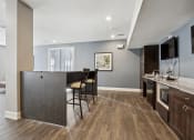 Thumbnail 7 of 22 - a kitchen and living room with a bar and a table with chairs