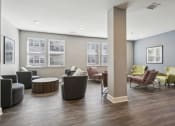 Thumbnail 6 of 22 - a community room with couches chairs and tables and windows at The Lofts apartments in Slidell, LA
