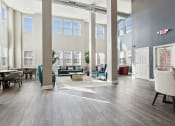 Thumbnail 3 of 22 - a lobby with couches chairs and tables and large windows at The Lofts in Slidell